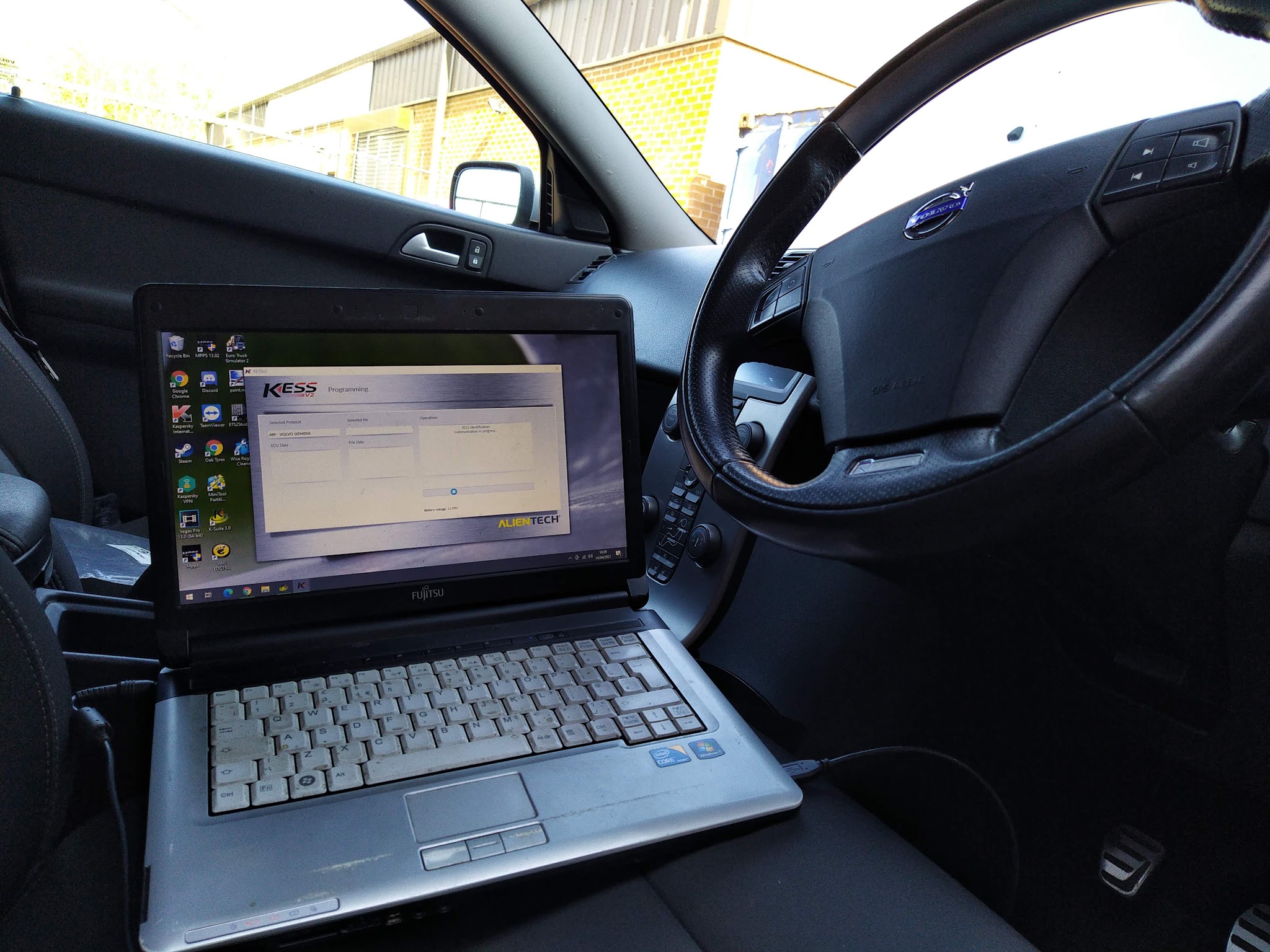 A diagnostic laptop connected inside a car